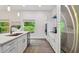 Clean white kitchen with stainless steel appliances and quartz countertops at 6439 Taylor Ct, New Port Richey, FL 34653