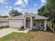 One-story house with a white garage door and landscaping at 6439 Taylor Ct, New Port Richey, FL 34653