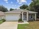One-story house with a white garage door and landscaping at 6439 Taylor Ct, New Port Richey, FL 34653