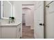 Bathroom with vanity and view of hallway at 6439 Taylor Ct, New Port Richey, FL 34653