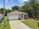 Newly built home with a single-car garage and welcoming front porch at 6439 Taylor Ct, New Port Richey, FL 34653