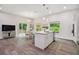 Modern kitchen with island, stainless steel appliances, and breakfast nook at 6439 Taylor Ct, New Port Richey, FL 34653