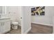 Modern bathroom with white vanity, toilet and view of hallway at 6439 Taylor Ct, New Port Richey, FL 34653