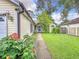 Side view of house showcasing a walkway, landscaping and exterior features at 5001 80Th Avenue E Cir, Sarasota, FL 34243