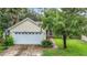 House exterior featuring a two-car garage and a basketball hoop at 5001 80Th Avenue E Cir, Sarasota, FL 34243