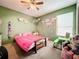 Bedroom with pink bedding, closet, and playful decor at 5001 80Th Avenue E Cir, Sarasota, FL 34243