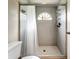 Shower stall with tile surround and a small window at 5001 80Th Avenue E Cir, Sarasota, FL 34243