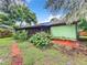 Landscaped backyard with lush greenery and brick path at 5001 80Th Avenue E Cir, Sarasota, FL 34243