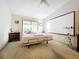 Main bedroom with a large bed and a projector screen at 5001 80Th Avenue E Cir, Sarasota, FL 34243