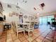 Dining area with glass-top table, six chairs, and access to living room at 5001 80Th Avenue E Cir, Sarasota, FL 34243