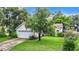 House exterior showcasing a large yard, basketball hoop and landscaping at 5001 80Th Avenue E Cir, Sarasota, FL 34243