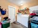 Laundry room with washer, dryer, and extra storage at 5001 80Th Avenue E Cir, Sarasota, FL 34243