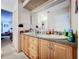 Bathroom with double sinks, granite countertop, and view of bedroom at 5001 80Th Avenue E Cir, Sarasota, FL 34243