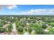 Aerial view of a residential neighborhood with mature trees and a paved road at 5001 80Th Avenue E Cir, Sarasota, FL 34243