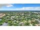 Aerial view showcasing a community of homes nestled amongst greenery and a lake at 5001 80Th Avenue E Cir, Sarasota, FL 34243