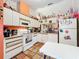 Bright kitchen with white appliances and orange accents at 5001 80Th Avenue E Cir, Sarasota, FL 34243