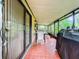 Relaxing screened porch with table, chairs, and grill at 5001 80Th Avenue E Cir, Sarasota, FL 34243
