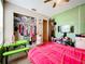 Bedroom with pink bedding, a closet, and a small desk at 5001 80Th Avenue E Cir, Sarasota, FL 34243