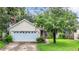 Charming yellow house with a two-car garage and well-maintained lawn at 5001 80Th Avenue E Cir, Sarasota, FL 34243
