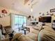 Living room with two sofas, coffee table, and access to patio at 5001 80Th Avenue E Cir, Sarasota, FL 34243