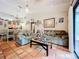 Living room with sofa, coffee table, and access to patio at 5001 80Th Avenue E Cir, Sarasota, FL 34243