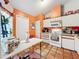 Kitchen with white cabinets and orange walls at 5001 80Th Avenue E Cir, Sarasota, FL 34243