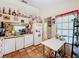 View of kitchen with white cabinets and tile floor at 5001 80Th Avenue E Cir, Sarasota, FL 34243