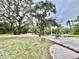 Spacious backyard with lush trees and seating area at 1109 Belcher Rd, Palm Harbor, FL 34683