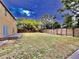 Expansive backyard featuring a wood fence providing privacy and a large grassy area at 1109 Belcher Rd, Palm Harbor, FL 34683