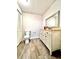 Simple bathroom with a vanity, toilet, and tile flooring at 1109 Belcher Rd, Palm Harbor, FL 34683