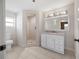 Bright bathroom featuring tile floors, walk-in shower, and vanity with a mirror at 1109 Belcher Rd, Palm Harbor, FL 34683