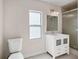 Bathroom featuring a vanity with storage, a tiled shower, and a bright window at 1109 Belcher Rd, Palm Harbor, FL 34683