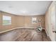 Bedroom featuring hardwood floors and natural light from two windows at 1109 Belcher Rd, Palm Harbor, FL 34683