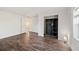 Empty bedroom with a closet, hardwood floors, and an open door that leads to another room at 1109 Belcher Rd, Palm Harbor, FL 34683
