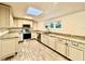 Modern kitchen with granite countertops, stainless steel appliances, and skylight at 1109 Belcher Rd, Palm Harbor, FL 34683
