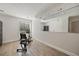 Bright exercise room featuring wood-look tile flooring and mirrored wall at 1109 Belcher Rd, Palm Harbor, FL 34683