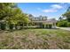 Charming yellow two-story home with black shutters and a welcoming front porch at 1109 Belcher Rd, Palm Harbor, FL 34683