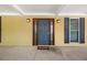Elegant front door with decorative glass sidelights and stylish lighting fixtures at 1109 Belcher Rd, Palm Harbor, FL 34683