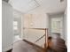 Bright hallway featuring hardwood floors, access to multiple rooms, and a decorative ceiling light at 1109 Belcher Rd, Palm Harbor, FL 34683