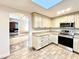 Bright kitchen featuring white cabinets and stainless steel appliances at 1109 Belcher Rd, Palm Harbor, FL 34683