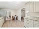 Eat in kitchen with dining table and view to the stairs at 1109 Belcher Rd, Palm Harbor, FL 34683