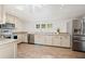 Bright kitchen features granite countertops, stainless appliances, and tile floors at 1109 Belcher Rd, Palm Harbor, FL 34683