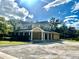 Two-story house with a wraparound porch and large parking area at 1109 Belcher Rd, Palm Harbor, FL 34683