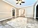 Neutral living room with an area rug and arched doorways to other rooms at 1109 Belcher Rd, Palm Harbor, FL 34683
