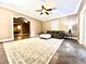 Cozy living room with a ceiling fan, an area rug, and an arched doorway at 1109 Belcher Rd, Palm Harbor, FL 34683