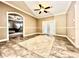 Neutral living room with arched doorways, area rug and French doors at 1109 Belcher Rd, Palm Harbor, FL 34683