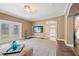 Open living room with French doors, television, and view of the kitchen at 1109 Belcher Rd, Palm Harbor, FL 34683