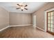 Spacious living room with tile flooring, ceiling fan, and neutral paint scheme at 1109 Belcher Rd, Palm Harbor, FL 34683