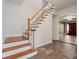View of the staircase featuring wooden steps with white risers and a wooden railing at 1109 Belcher Rd, Palm Harbor, FL 34683