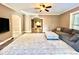 Bright living room featuring hardwood floors, an area rug and ceiling fan at 1109 Belcher Rd, Palm Harbor, FL 34683